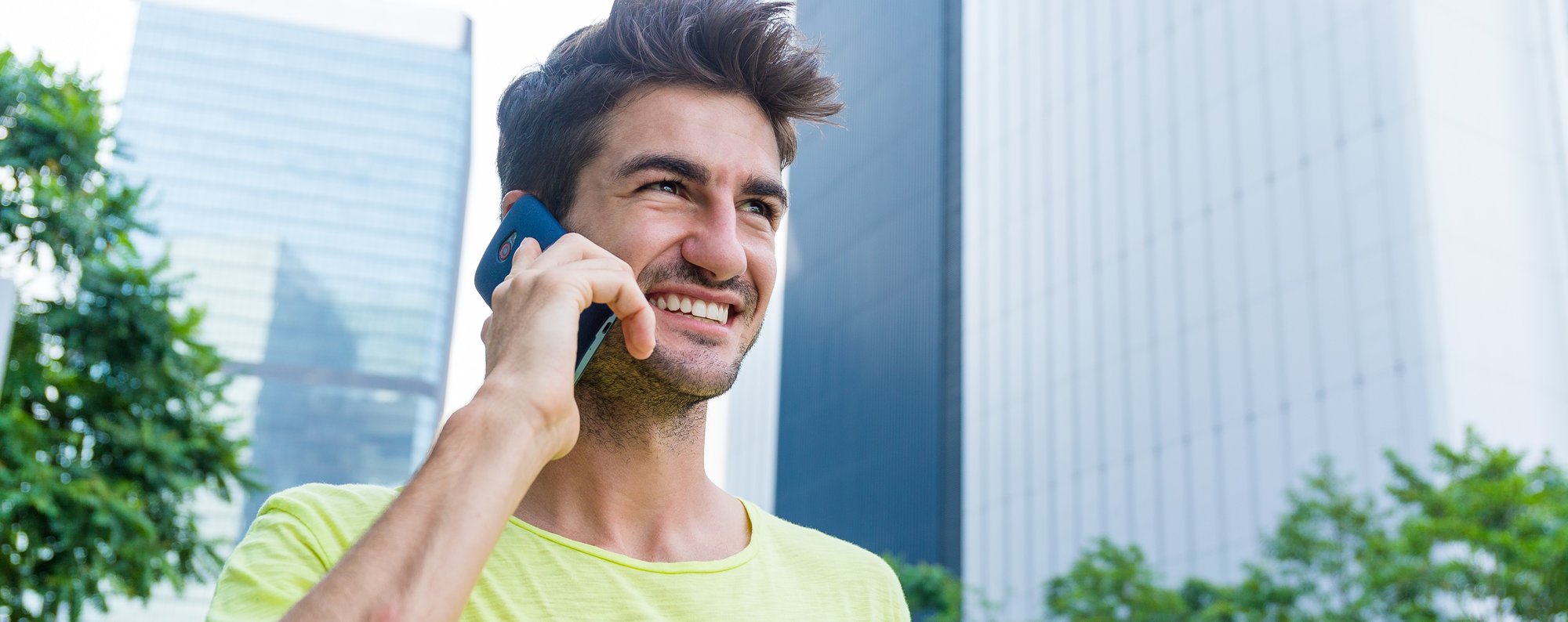 caucasian-man-talk-to-cellphone-at-outdoor-2TS7WEM
